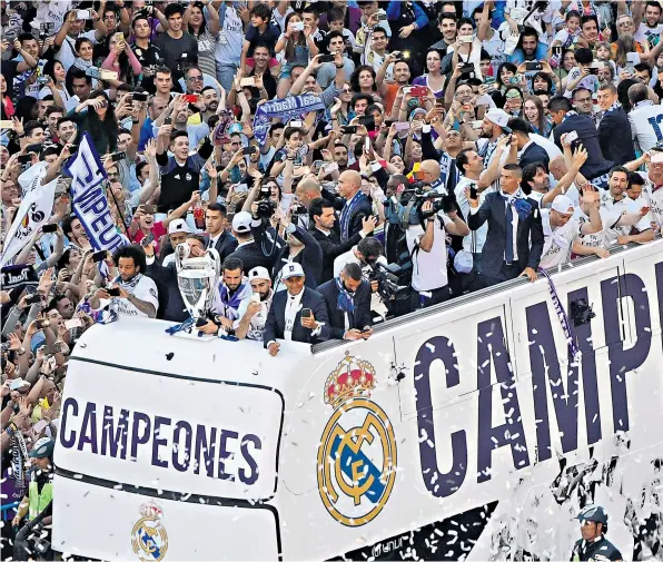  ??  ?? Victory parade: Real Madrid’s players and staff are hailed by their fans