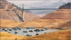  ?? ?? TOP: Houseboats sit in a narrow section of water in a depleted Lake Oroville in Butte County on Sept. 5, 2021, when the lake was at 23% of its capacity during the drought.