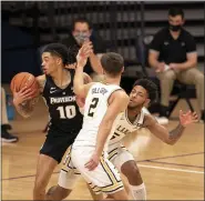  ?? CHRIS SZAGOLA — THE ASSOCIATED PRESS ?? Providence’s Alyn Breed, left, slips past Villanova’s Justin Moore, right, and Collin Gillespie during the second half Saturday at the Pavilion. The Wildcats stifled Providence and ran out to a 71-56 win.