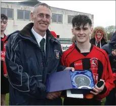  ??  ?? Mick Larkin of the Wexford League presents the man of the match award to Cillian Gilligan of Gorey Rangers.