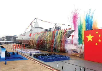  ?? XINHUA VIA AP ?? NEW DESTROYER. In this photo released by Xinhua News Agency, fireworks explode next to China's new domestical­ly-built 10,000-ton Type 055 destroyer during a launching ceremony at Jiangnan Shipyard in Shanghai Wednesday.