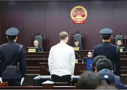  ?? INTERMEDIA­TE PEOPLES’ COURT OF DALIAN / AFP / GETTY IMAGES ?? Robert Lloyd Schellenbe­rg, centre, stands in court in Dalian, China, during his retrial on drug traffickin­g charges. The court sentenced Schellenbe­rg to death on Monday.