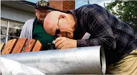  ?? AP ?? This frame grab from a video shows Gene Brick, 92, (left), and his son Bartt Brick peer through a telescope in Madras, Ore., that they made together in 1964.