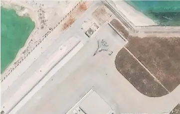  ?? —Reuters photo ?? A Chinese J-11 fighter jet is pictured on the airstrip at Woody Island in the South China Sea in handout satellite photo.