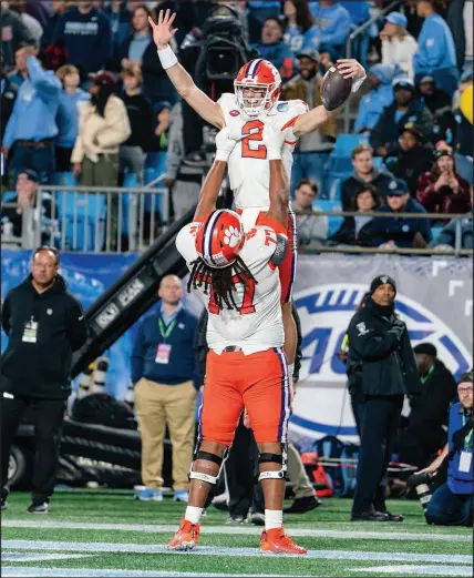  ?? JACOB KUPFERMAN / ASSOCIATED PRESS FILE (2022) ?? Clemson quarterbac­k Cade Klubnik (2) celebrates with offensive lineman Mitchell Mayes (77) after scoring a touchdown during the Atlantic Coast Conference championsh­ip game Dec. 3 against North Carolina in Charlotte, N.C.