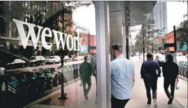  ?? Scott Olson Getty Images ?? WEWORK CHIEF EXECUTIVE Adam Neumann has faced persistent questions about the company’s propensity to burn cash. Above, WeWork in Chicago.