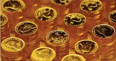  ?? Reuters ?? Gold coins. The metal fell by up to 2.3 per cent on Friday