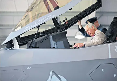  ??  ?? The Prince of Wales in an F-35 Lightning II stealth fighter jet yesterday during a visit to RAF Marham in Norfolk, and below, with Peter Ball, the former Bishop of Gloucester, in 1992