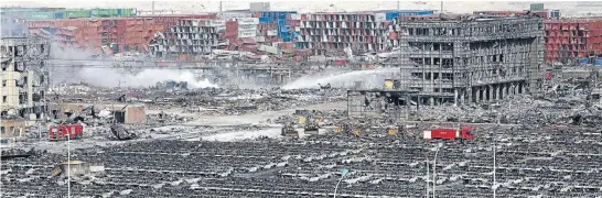  ?? Photo: REUTERS ?? Firefighte­rs work at the site of the explosions in Tianjin where toxic chemicals and gas were stored in the northeast Chinese port city, killing at least 54 people.