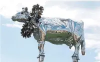  ?? STEVE RUSSELL/TORONTO STAR FILE PHOTO ?? The cow statue sits on stilts on Markham’s Charity Cres.