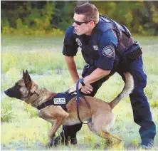  ?? PHOTOS COURTESY OF YARMOUTH POLICE DEPARTMENT ?? ‘GET HIM THROUGH THIS’: Injured Yarmouth police K-9 Nero sniffs at, left, and stands in, below, the cruiser of his slain handler, Sgt. Sean Gannon, above, at Cape Cod Veterinary Hospital. Hospital staff gather to send Nero off, below left.