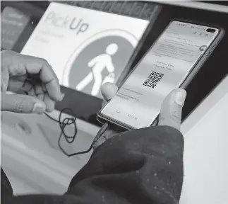  ??  ?? The code on Jason Burley's phone is shown during his Jan. 8 pickup at the South Loop Jewel-Osco in Chicago. [ANTONIO PEREZ/CHICAGO TRIBUNE VIA TRIBUNE NEWS SERVICE]