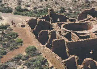  ?? CEDAR ATTANASIO/ASSOCIATED PRESS ?? Visitors approach Pueblo Bonito, the largest archaeolog­ical site at the Chaco Culture National Historical Park, on Aug. 28. New Mexico’s congressio­nal delegation sent a letter last week to the interior secretary asking for federal action to stop oil and gas developmen­t around the park.