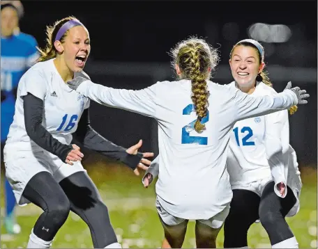  ?? SEAN D. ELLIOT/THE DAY ?? Old Lyme’s Danielle McCarthy (2) races to celebrate her goal with teammates Maddie Ouellette (16) and Mya Johnson (12) during Tuesday night’s Class S girls’ soccer tournament semifinal against St. Paul at Falcon Field in Meriden. The top-seeded and...