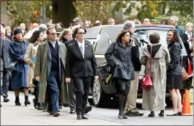  ?? KEITH SRAKOCIC — THE ASSOCIATED PRESS ?? Visitors walk past the hearse as they gather for the funeral of Rose Mallinger, 97, at Congregati­on Rodef Shalom on Friday in Pittsburgh. Mallinger was one of the eleven victims killed in the deadly shooting at a synagogue in Pittsburgh’s Squirrel Hill neighborho­od last Saturday.