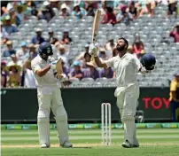  ?? Reuters ?? Cheteshwar Pujara (right) celebrates his century with captain Virat Kohli applauding on day two of the third Test. —