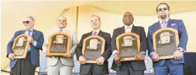  ?? Hans Pennink / Associated Press ?? New Baseball Hall of Famers show their plaques. From left, Bud Selig, Ivan Rodriguez, John Schuerholz, Tim Raines, and Jeff Bagwell.