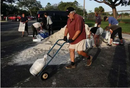  ?? Photograph: Joe Cavaretta/AP ?? Sandbags are distribute­d at Mills Pond Park in Fort Lauderdale, Florida, ahead of Tropical Storm Nicole on Tuesday.
