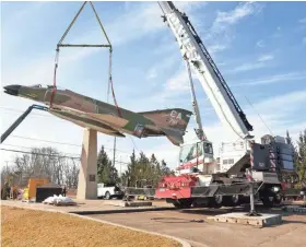  ?? TOM CALDART / MOVING PICTURES WISCONSIN ?? Crews work on removing the jet from its original location at the old 440th Airlift Wing compound on College Ave., just east of Howell Ave., last week.
