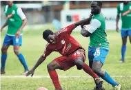  ?? FILE ?? Boy’s Town’s Andrew Allen (left) stumbles under pressure from Montego Bay United’s Dino Williams during a 2016 Red Stripe Premier League match.