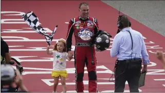  ?? PAUL SANCYA — THE ASSOCIATED PRESS ?? Kevin Harvick celebrates with daughter Piper after winning the NASCAR Cup race at Michigan Internatio­nal Speedway on Sunday. The victory ended a 65-race winless drought for Harvick, who is ninth in the points race.