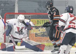  ?? ?? Kohltech Valley Wildcats goalie Samuel Sinclair makes a shoulder save during the first period of Game 5 of a Nova Scotia Under-18 Major Hockey League quarter-final with the Cape Breton West Islanders.