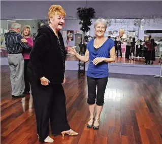  ??  ?? Dance away: Ballroom dancing is good for the heart, says
dance instructor June Rawls
(in black), co-owner of Bijoux Dance Center. She is seen here with one of her students, Kimberly
Kiddoo Jarrett (in
blue).