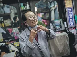  ?? Marcus Yam Los Angeles Times ?? “NO MATTER how much the world changes, people still need their hair cut,” says South Korean barber Lee Duk-hoon, 85, who has endured war and poverty.