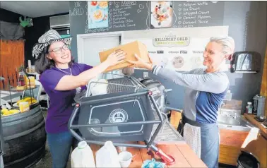  ??  ?? Deborah Burnside delivers coffee cups to Dropshot Kaffee owner Karen Kriese-Wise, for the upcoming NETs Awareness campaign.