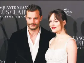  ?? Francois Mori / Associated Press ?? Jamie Dornan, left, and Dakota Johnson pose during a photocall for the world premiere of “Fifty Shades Freed — 50 Nuances Plus Claires” at Salle Pleyel in Paris.