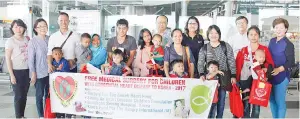  ??  ?? SOSHF vice president Datuk William Chai (back row, third right) and Eva (back row, second right) with the seven children and their family members at KKIA yesterday before flying to Korea to undergo corrective heart surgery.