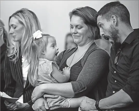  ?? [JOSHUA A. BICKEL/DISPATCH] ?? Brandon Ward teases with his daughter, Ellie, 3, after testifying during an Ohio General Assembly health committee hearing at the Statehouse on Wednesday. Ward spoke to the group along with his wife, Jackie, holding their daughter. The bill, introduced...