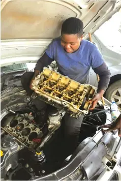  ?? ?? Ms Mapondera fixes a client’s vehicle