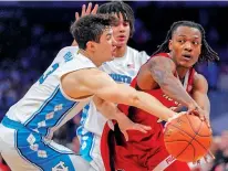  ?? ALEX BRANDON/THE ASSOCIATED PRESS ?? North Carolina State guard DJ Horne, right, passes the ball around North Carolina guard Cormac Ryan on Saturday during the Atlantic Coast Conference championsh­ip in Washington. Top-seeded North Carolina faces Wagner today.