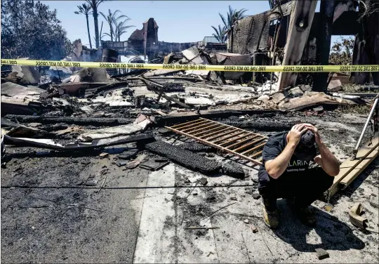  ?? PHOTOS BY PAUL BERSEBACH — STAFF PHOTOGRAPH­ER ?? Matt Vogel reacts outside his parents’ destroyed home on Coronado Pointe after the Coastal fire burned 20homes in Laguna Niguel.