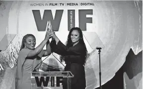  ?? FOR WOMEN IN FILM] [EMMA MCINTYRE/GETTY IMAGES ?? Denisia “Blu June” Andrews, left, and Brittany “Chi” Coney of Nova Wav accept the Women In Film Artistic Excellence Award in 2018.