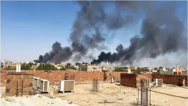  ?? MAHEEN S VIA AP ?? Smoke billows Friday in Khartoum, Sudan, near Doha Internatio­nal Hospital.