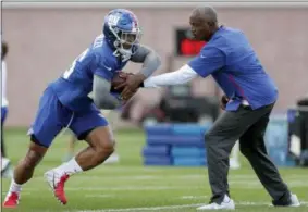  ?? JULIO CORTEZ — THE ASSOCIATED PRESS ?? New York Giants running back Saquon Barkley, left, takes a handoff during a drill at NFL football training camp, Thursday in East Rutherford, N.J.