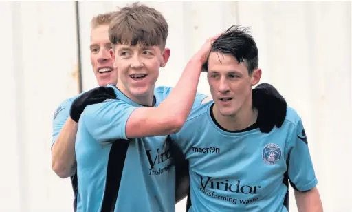  ?? Paul Watson ?? Runcorn Town players Mark Reed (left) and Tom Crawford (centre) congratula­te Craig Cairns on his goal against Winsford United earlier in the season.