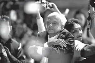  ?? MOISES CASTILLO/ASSOCIATED PRESS ?? Mexico presidenti­al election winner Andrés Manuel López Obrador acknowledg­es his supporters as he arrives to Mexico City’s main square, the Zocalo, on Sunday.