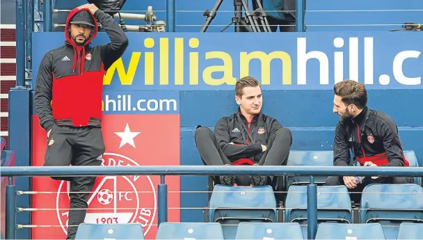  ??  ?? SITTING IT OUT: From left, Aberdeen’s Shay Logan, Kenny McLean and Graeme Shinnie in the stands at Hampden on Saturday