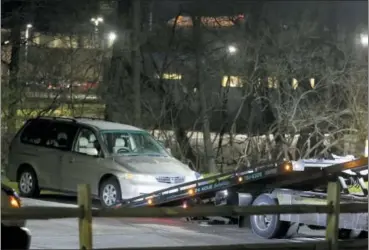  ?? CARA OWSLEY — THE CINCINNATI ENQUIRER VIA AP, FILE ?? A minivan is removed from the parking lot near the Seven Hills School campus in Cincinnati. The desperate last words of a 16-year-old boy who told a 911 operator “I’m going to die here” continue to hang over Cincinnati, eight months after the death of Kyle Plush on April 10 after he was trapped in the family minivan. This was one of Ohio’s top stories of 2018.