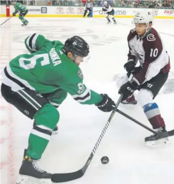  ?? LM Otero, The Associated Press ?? Dallas Stars defenseman Julius Honka and Colorado Avalanche right winger Sven Andrighett­o get crossed up as they battle for the puck during the first period of Saturday night’s game in Dallas. The Stars downed the Avalanche 3-1, dropping Colorado’s...
