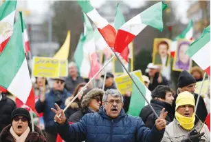  ?? (Francois Lenoir/Reuters) ?? PROTESTERS CHANT slogans during a protest against the visit of Iran’s Foreign Minister Mohammad Javad Zarif, outside the European Union Council in Brussels on Wednesday.