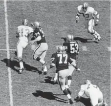  ?? Denver Post file ?? Steve Tensi, trying to break away from the Raiders’ pass rush in September 1967, was one of three quarterbac­ks the Broncos used that season. The Broncos lost this game 51-0.