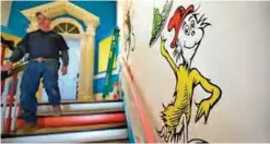  ??  ?? A man walks past a mural with the character "Sam-I-Am" from the Dr Seuss book "Green Eggs and Ham" at The Amazing World of Dr Seuss Museum.