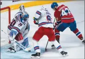  ?? THE CANADIAN PRESS/PAUL CHIASSON ?? Montreal Canadiens' Alexander Radulov scores past New York Rangers goaltender Henrik Lundqvist as Rangers' Mika Zibanejad covers during overtime Game 2 NHL Stanley Cup first round playoff hockey action Friday in Montreal.