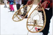  ?? AP PHOTO BY CLAIRE CUDAHY ?? In this Jan. 2 photo, young members of the Washoe Tribe in northern Nevada display snowshoes they crafted on the outskirts of Hope Valley southwest of Lake Tahoe.