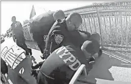  ?? NYPD ?? In a photo taken from video, New York police officers arrest a man Sunday on the Rockaway Beach boardwalk. One officer was suspended for using a chokehold in the arrest.