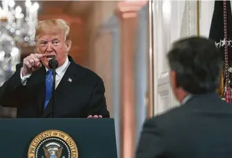  ?? Jim Watson / AFP/Getty Images ?? President Donald Trump points to CNN journalist Jim Acosta during a post-election news conference at the White House on Wednesday. An aide then took the microphone from Acosta.